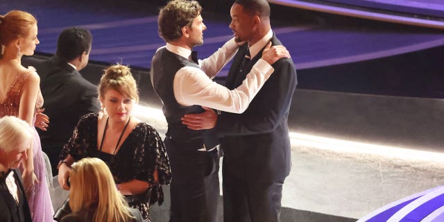 Bradley Cooper comforts Will Smith during the 94th Academy Awards at the Dolby Theatre at Ovation Hollywood Sunday, March 27, 2022.