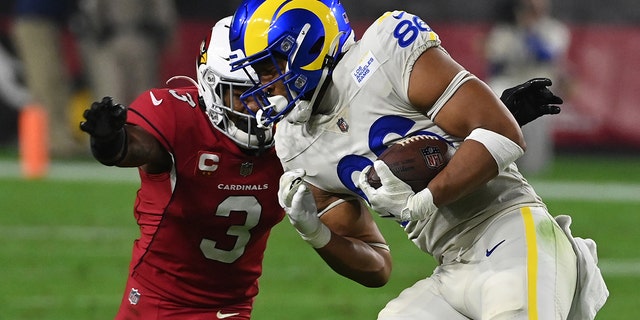 Kendall Blanton #86 of the Los Angeles Rams runs with the ball as Budda Baker #3 of the Arizona Cardinals attempts to make a tackle at State Farm Stadium on December 13, 2021 in Glendale, Arizona.