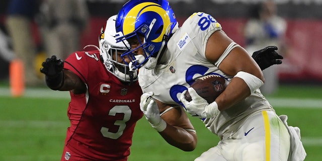 Kendall Blanton #86 of the Los Angeles Rams runs with the ball as Budda Baker #3 of the Arizona Cardinals attempts to make a tackle at State Farm Stadium on December 13, 2021 in Glendale, Arizona.