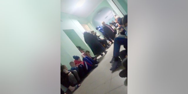 Colleen Thompson shared this image showing Ukraine orphans, including their future daughter, sitting in the hallway of a building in Lviv, as "there was concern about bombings." Said Thompson, working hard to stay steady as she spoke, "We are working to get them released with appropriate approval and moved across the border into Poland."