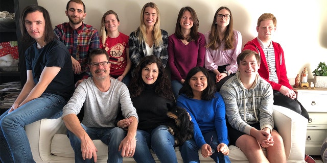 The Thompson family of Kentucky, along with a friend — but minus "M," whom they're trying to adopt from Ukraine. The parents, David (in light gray shirt) and Colleen (in black shirt), are seated in the front row, on the left.