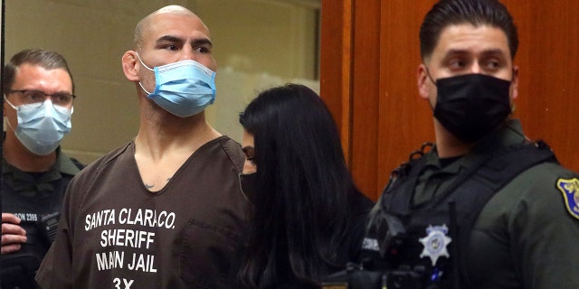 Former UFC heavyweight champion Cain Velasquez, second from left, with his attorney Alexandra Kazarian, makes an initial court appearance at the Santa Clara County Hall of Justice on Wednesday, March 2, 2022, in San Jose, California