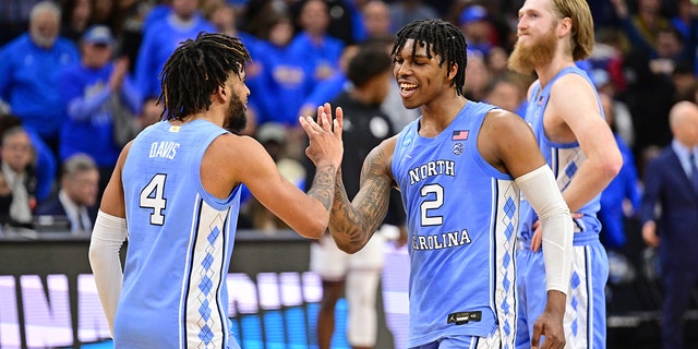 R.J. Davis (4) of the North Carolina Tar Heelsand Caleb Love (2) of the North Carolina Tar Heels celebrate against the UCLA Bruins during the Sweet 16 round of the 2022 NCAA Men's Basketball Tournament held at Wells Fargo Center on March 25, 2022 in Philadelphia, Pennsylvania.