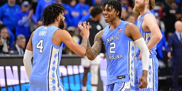 R.J. Davis (4) of the North Carolina Tar Heelsand Caleb Love (2) of the North Carolina Tar Heels celebrate against the UCLA Bruins during the Sweet 16 round of the 2022 NCAA Men's Basketball Tournament held at Wells Fargo Center on March 25, 2022 in Philadelphia, Pennsylvania.