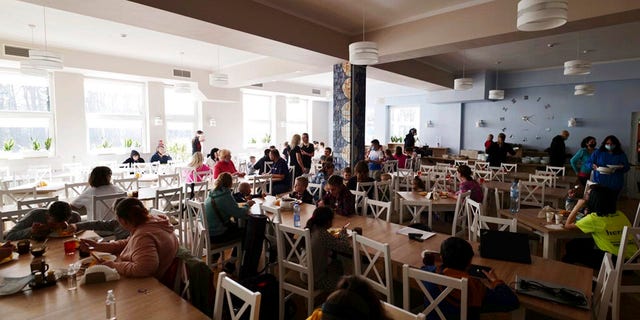 Children eat lunch at a clinic in Bocheniec, Poland, on Thursday, March 17, 2022.