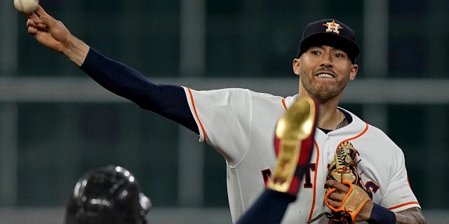 File - Houston Astros shortstop Carlos Correa pitched for the Boston Red Sox after Christian Arroyo hit a double play in the second inning in Game 1 of baseball's American League Championship Series on Oct. 15, 2021 in Houston. Alex Verdago was sent off in second place.