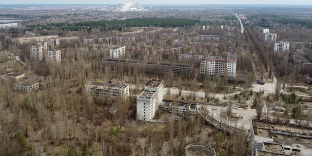 A New Safe Confinement (NSC) structure over the old sarcophagus covering the damaged fourth reactor at the Chernobyl Nuclear Power Plant is seen behind the abandoned town of Pripyat, Ukraine. Workers at the plant said Russian soldiers disturbed radioactive dust and failed to wear protective gear after taking control of the site. 