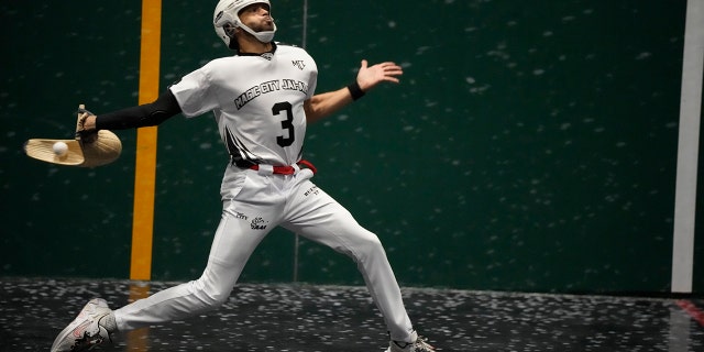 Chris Bueno returns a ball in a Jai Alai match at the Magic City Casino fronton, Sunday, March 13, 2022, in Miami.