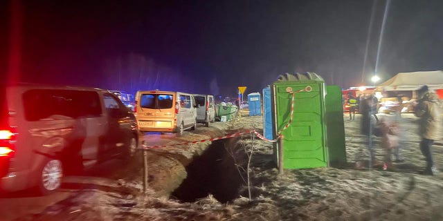 Vans are shown lined up near the Poland-Ukraine border.