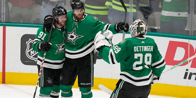Dallas Stars center Tyler Seguin (91) celebrates his empty-net goal with Jani Hakanpaa (2) and goaltender Jake Oettinger (29) during the third period of the team's NHL hockey game against the Edmonton Oilers in Dallas, Tuesday, March 22, 2022. The Stars won 5-3.