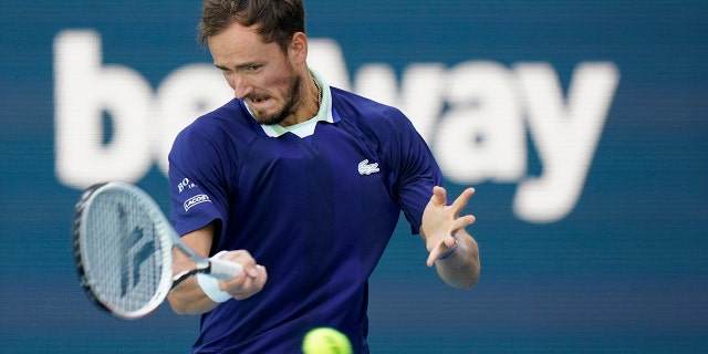 Daniil Medvedev of Russia returns a shot from Jenson Brooksby, during the Miami Open tennis tournament, Tuesday, March 29, 2022, in Miami Gardens, Fla.