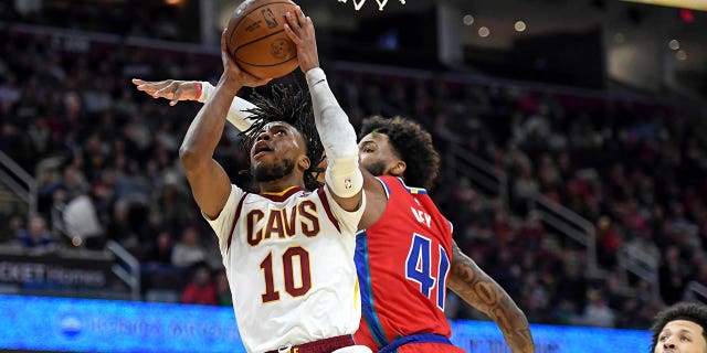 Cleveland Cavaliers' Darius Garland (10) shoots next to Detroit Pistons' Saddiq Bey (41) during the first half of an NBA basketball game Saturday, March 19, 2022, in Cleveland.