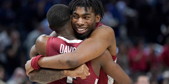Arkansas guard Dazute Davis, left, celebrates with striker Kamani Johnson after Arkansas defeated Gonzaga in a college basketball game in the Sweet 16 round of the NCAA tournament in San Francisco on Thursday, March 24, 2022.