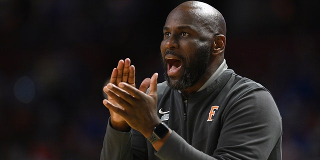 Head coach Dedrique Taylor of the Cal State Fullerton Titans cheers on his team against the Duke Blue Devils during the first round of the 2022 NCAA Men's Basketball Tournament held at Bon Secours Wellness Arena on March 18, 2022 in Greenville, Suid Carolina.