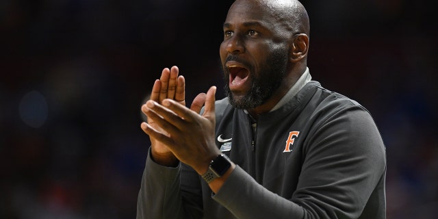 Head coach Dedrique Taylor of the Cal State Fullerton Titans cheers on his team against the Duke Blue Devils during the first round of the 2022 NCAA Men's Basketball Tournament held at Bon Secours Wellness Arena on March 18, 2022 in Greenville, 南卡罗来纳.