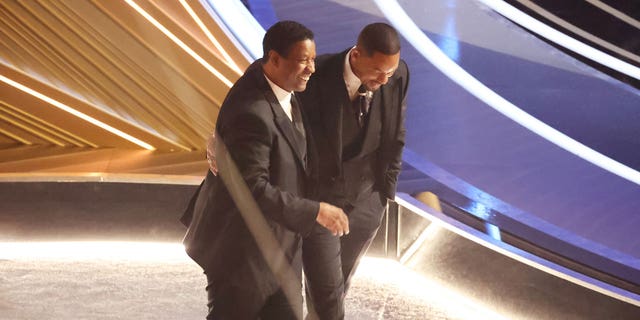 Denzel Washington comforts Will Smith during the show at the 94th Academy Awards on Sunday, March 27, 2022.
