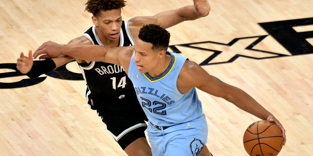 Memphis Grizzlies guard Desmond Bane (22) works against Brooklyn Nets forward Kessler Edwards (14) during the second half of an NBA basketball game Wednesday, March 23, 2022, in Memphis, Tenn. 