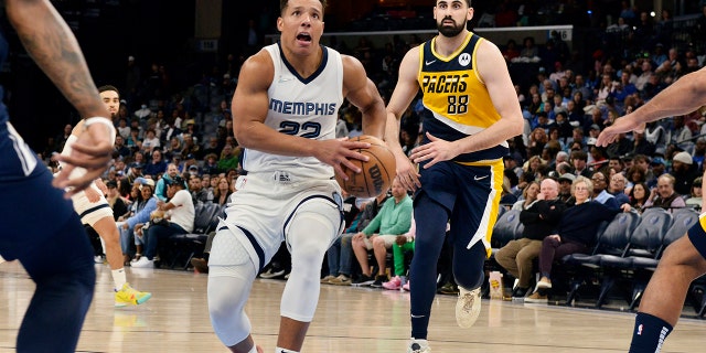 Memphis Grizzlies guard Desmond Bane (22) drives ahead of Indiana Pacers center Goga Bitadze (88) in the second half of an NBA basketball game Thursday, March 24, 2022, in Memphis, Tenn.