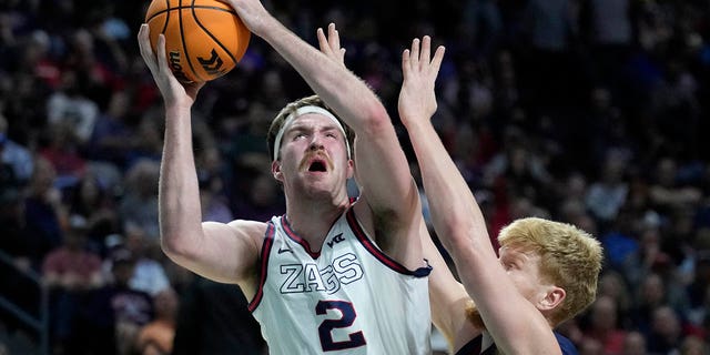 Saint Mary's Matthias Tass, right, fouls Gonzaga's Drew Timme (2) during the first half of the West Coast Conference tournament Tuesday, March 8, 2022, in Las Vegas. 