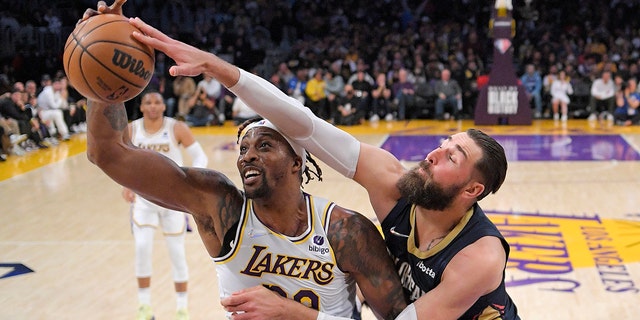Los Angeles Lakers center Dwight Howard, left, and New Orleans Pelicans center Jonas Valanciunas battle for a rebound during the first half of an NBA basketball game Sunday, Feb. 27, 2022, in Los Angeles.
