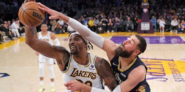 Los Angeles Lakers center Dwight Howard, left, and New Orleans Pelicans center Jonas Valanciunas battle for a rebound during the first half of an NBA basketball game Sunday, Feb. 27, 2022, in Los Angeles.