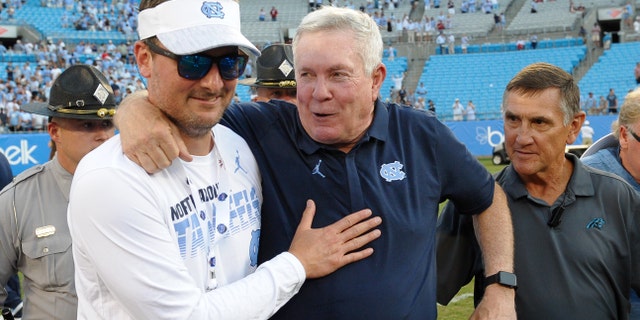 Church celebrates on the field with Tar Heels head coach Mack Brown after the Belk College Kickoff game between the South Carolina Gamecocks and the Tar Heels on Aug. 31, 2019, at Bank of America Stadium in Charlotte, North Carolina.