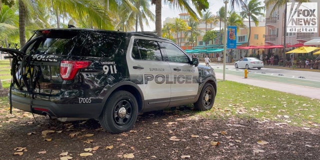Police car monitoring Ocean Drive on Miami Beach.