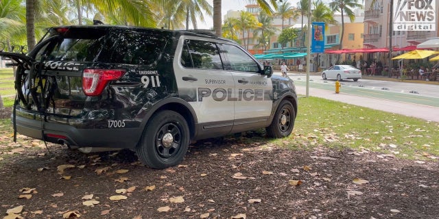 Police car monitoring Ocean Drive on Miami Beach.