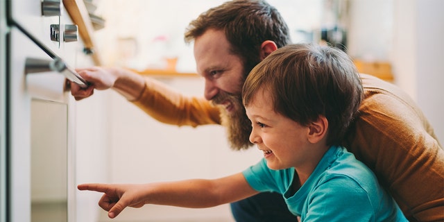 Father and son in the kitchen.  When was the last time you made a new mac and cheese dish for the whole family?  The recipe shared here can become a favorite for cooking time and again. 