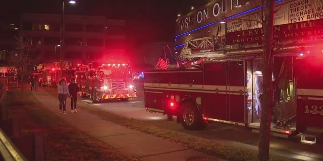 Fire trucks gathered outside the Fashion Outlets of Chicago shopping mall in Rosemont, Illinois Friday night. Two people were shot inside the outlet mall, police said. 