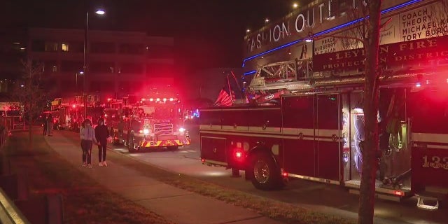 Fire trucks gathered outside the Fashion Outlets of Chicago shopping mall in Rosemont, Illinois Friday night. Two people were shot inside the outlet mall, police said.