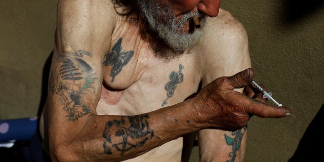 Travis Hayes, 65, injects what he says is the synthetic drug fentanyl on Feb. 27, 2020, across the street from where San Francisco mayor London Breed held a news conference introducing legislation to curb the rise of deadly overdoses in the city, at the Tenderloin section.