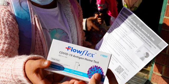 FILE - A second grade student is give an at-home COVID-19 test at H.W. Harkness Elementary School in Sacramento, Calif., on Feb. 11, 2022.