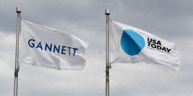 The corporate flags for the Gannett Co. and its flagship newspaper, USA Today, fly outside their corporate headquarters. 