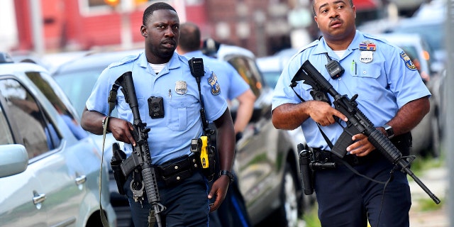 Police officers carrying assault rifles respond to a shooting on August 14, 2019 in Philadelphia, Pennsylvania. (Photo by Mark Makela/Getty Images)