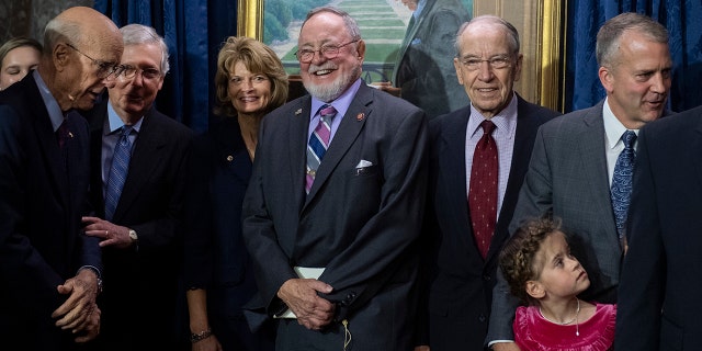 Rep. Don Young, center, and his colleagues are seen during a portrait unveiling for the late Sen. Ted Stevens, R-Alaska, in the Old Senate Chamber, Oct. 23, 2019.