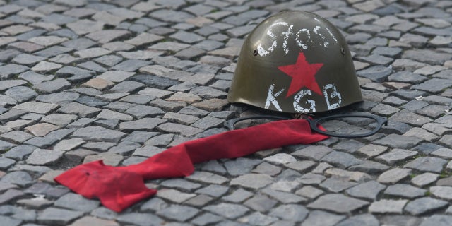 A Russian KGB/Stasi helmet in front of Brandenburg Gate in Berlin, just two days ahead of the 30th anniversary of the fall of the Berlin Wall, Nov. 7, 2019, in Berlin, Germany.