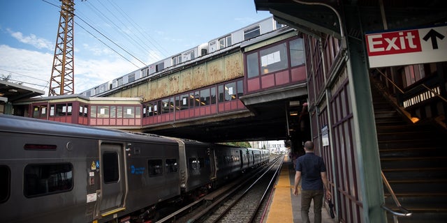 A commuter walks on the platform of the Woodside LIRR train station in the Queens borough of New York on Monday, Aug. 3, 2020.