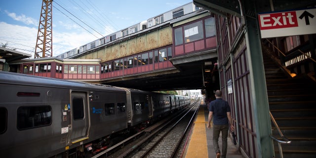 A commuter walks on the platform of the Woodside LIRR train station in the Queens borough of New York on Monday, Aug. 3, 2020.