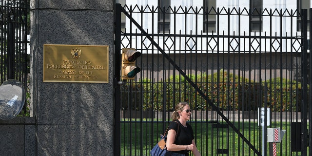 A pedestrian is seen in front of the Embassy of Russia in Washington, DC on April 15, 2021.