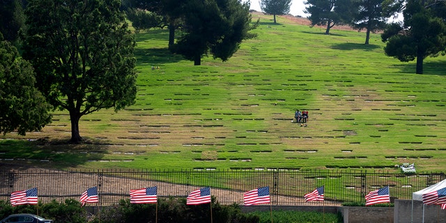 Several yards away on right Lance Cpl. Dylan Ryan Merola of Rancho Cucamonga is laid to rest at Forest Lawn Memorial Park in Covina on Sunday, Sept. 26, 2021. Merola was one of 13 service members killed in Afghanistan airport attack. 