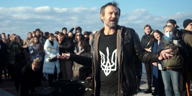 Lead vocalist Sviatoslav Vakarchuk is pictured during an impromptu open-air concert of the Okean Elzy rock band on the pedestrian and cycling bridge across Volodymyrskyi Descent, Kyiv, capital of Ukraine.