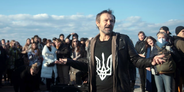 Lead vocalist Sviatoslav Vakarchuk is pictured during an impromptu open-air concert of the Okean Elzy rock band on the pedestrian and cycling bridge across Volodymyrskyi Descent, Kyiv, capital of Ukraine.