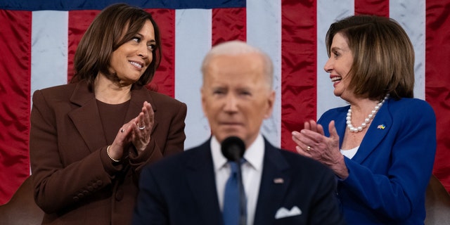 House Speaker Nancy Pelosi, a Democrat from California, right, and Vice President Kamala Harris talk as President Biden speaks during his State of the Union address at the U.S. Capitol in Washington March 1, 2022. 