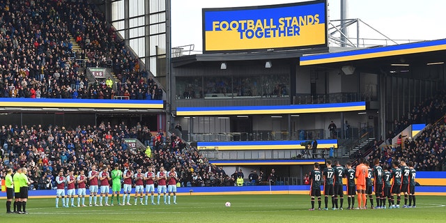 Players support Ukraine before the kick off during the Premier League match between Burnley and Chelsea at Turf Moor on March 5, 2022 in Burnley, United Kingdom.