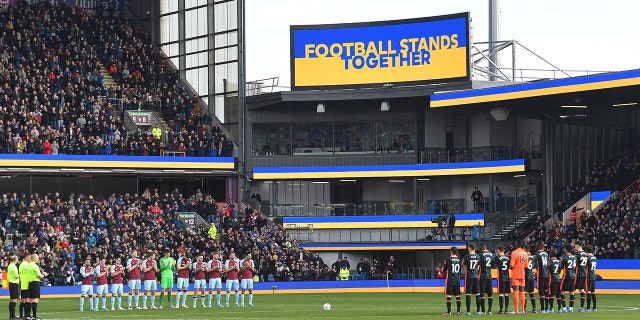 Players support Ukraine before the kick off during the Premier League match between Burnley and Chelsea at Turf Moor on March 5, 2022 in Burnley, United Kingdom.