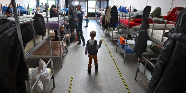 09 March 2022, Bavaria, Augsburg: A refugee boy from Ukraine holds a toy in his hand in the dormitory of the ANKER Center.