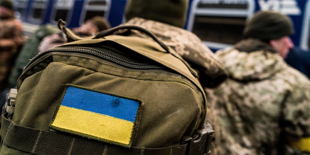 Soldiers watching the train arrive in Lviv as they prepare to travel to the frontline. (Photo by Vincenzo Circosta/SOPA Images/LightRocket via Getty Images)