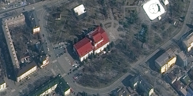 The word "children" is written in large white letters (in Russian) in front of and behind the Mariupol Drama Theater, which was bombed on March 16, 2022.