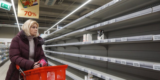 MOSCOW, RUSSIA - MARCH 16 (RUSSIA OUT): A woman looks at empty shelves in the sanitary napkin section at a shopping mall on March 16, 2022, in Moscow, Russia. Many worldwide brands have suspended any investment and sales in Russia over its military invasion on Ukraine.